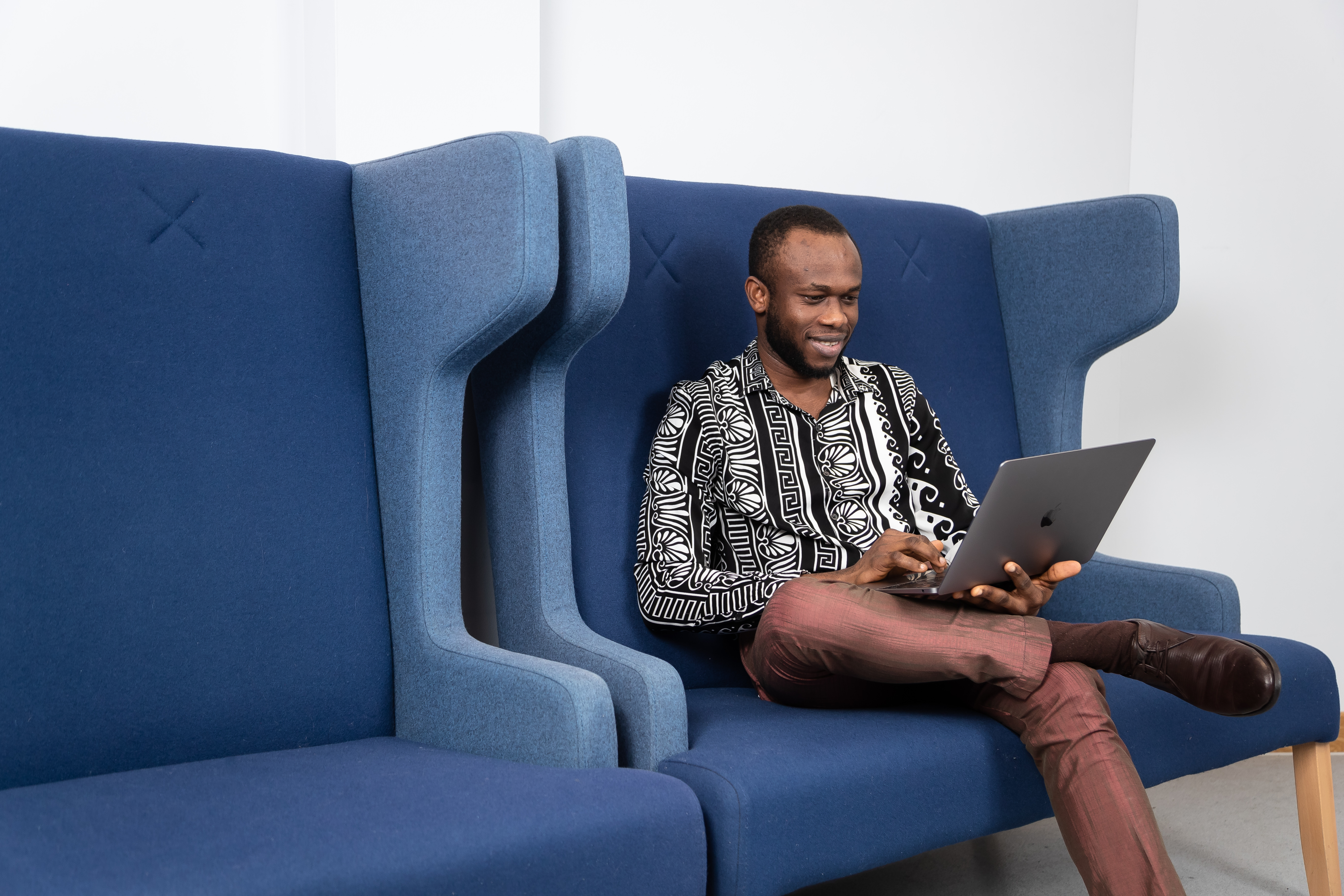 Guy on laptop sat on sofa