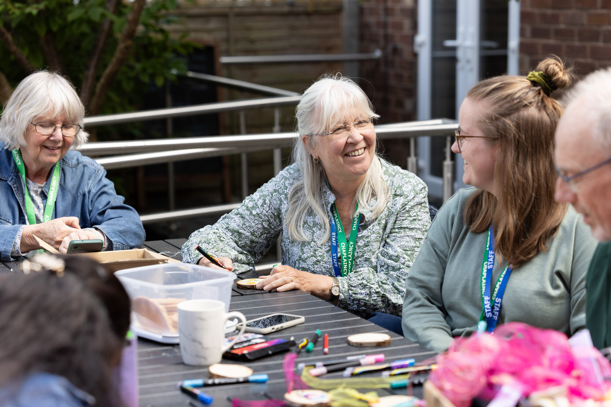 Chaplaincy group engaging in outdoor arts and crafts activity, fostering community and spiritual connection.