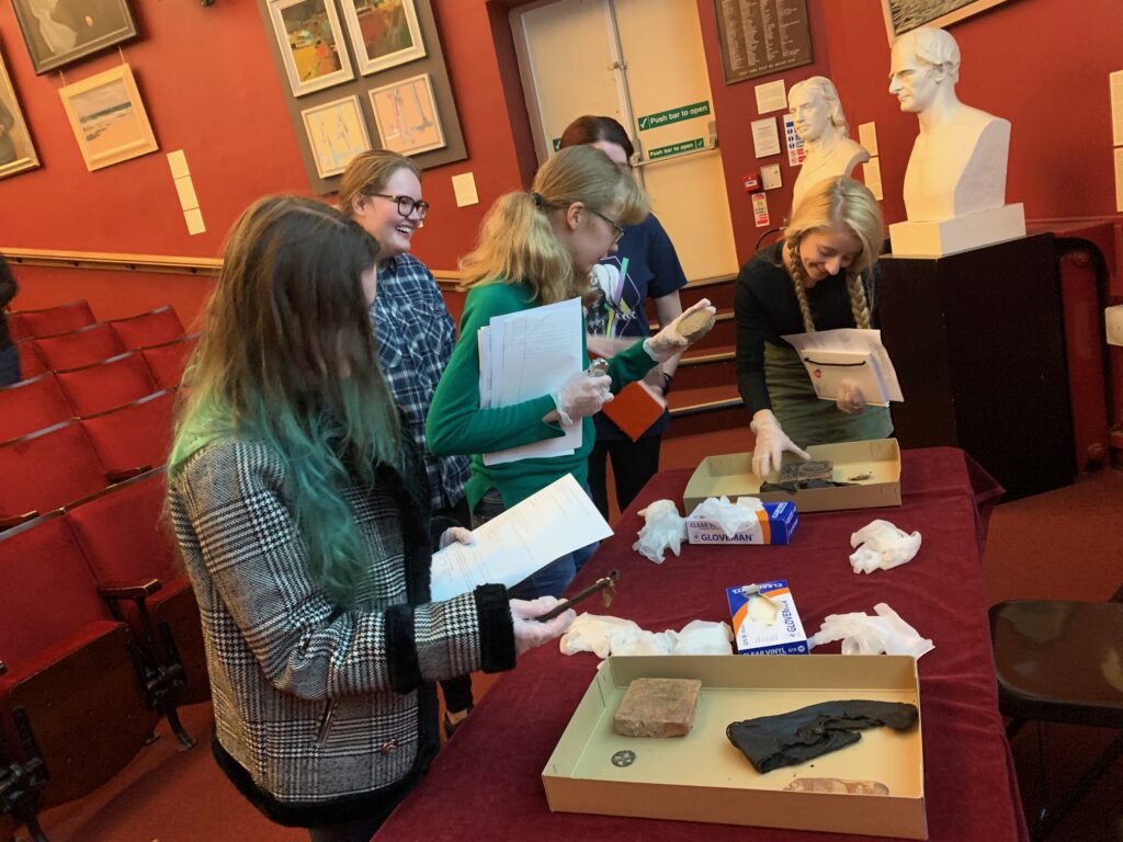 students engaging in handling historical artefacts