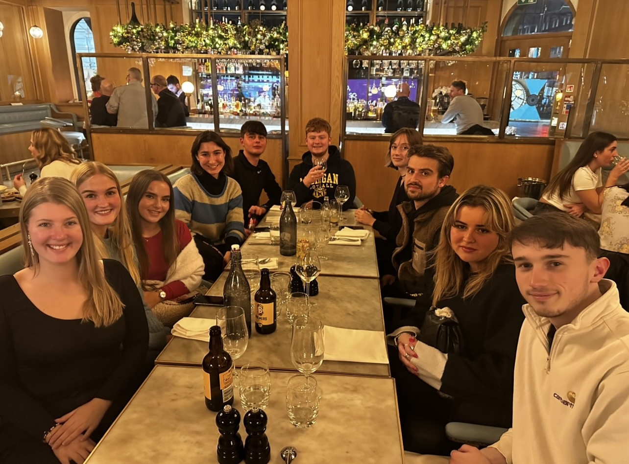 Ten students sat around a table at a restaurant