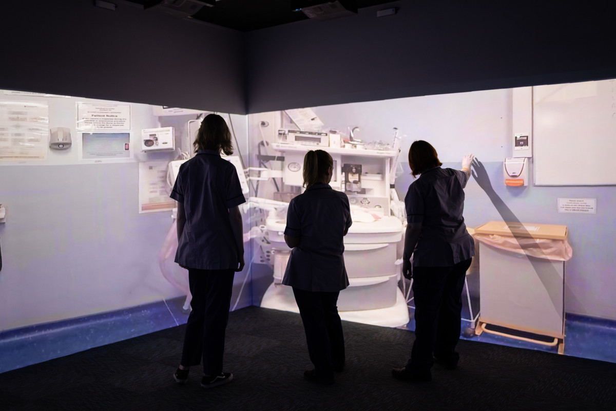Students engaged in an immersive virtual hospital simulation.
