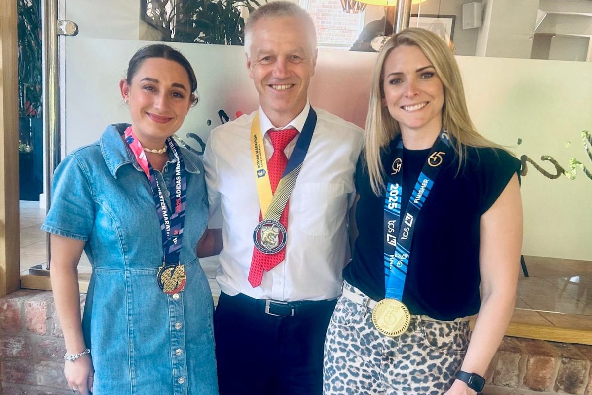 Becky Richardson, right, with fellow finance team members Lauren McLeod and Eddie Austin, with their marathon medals.