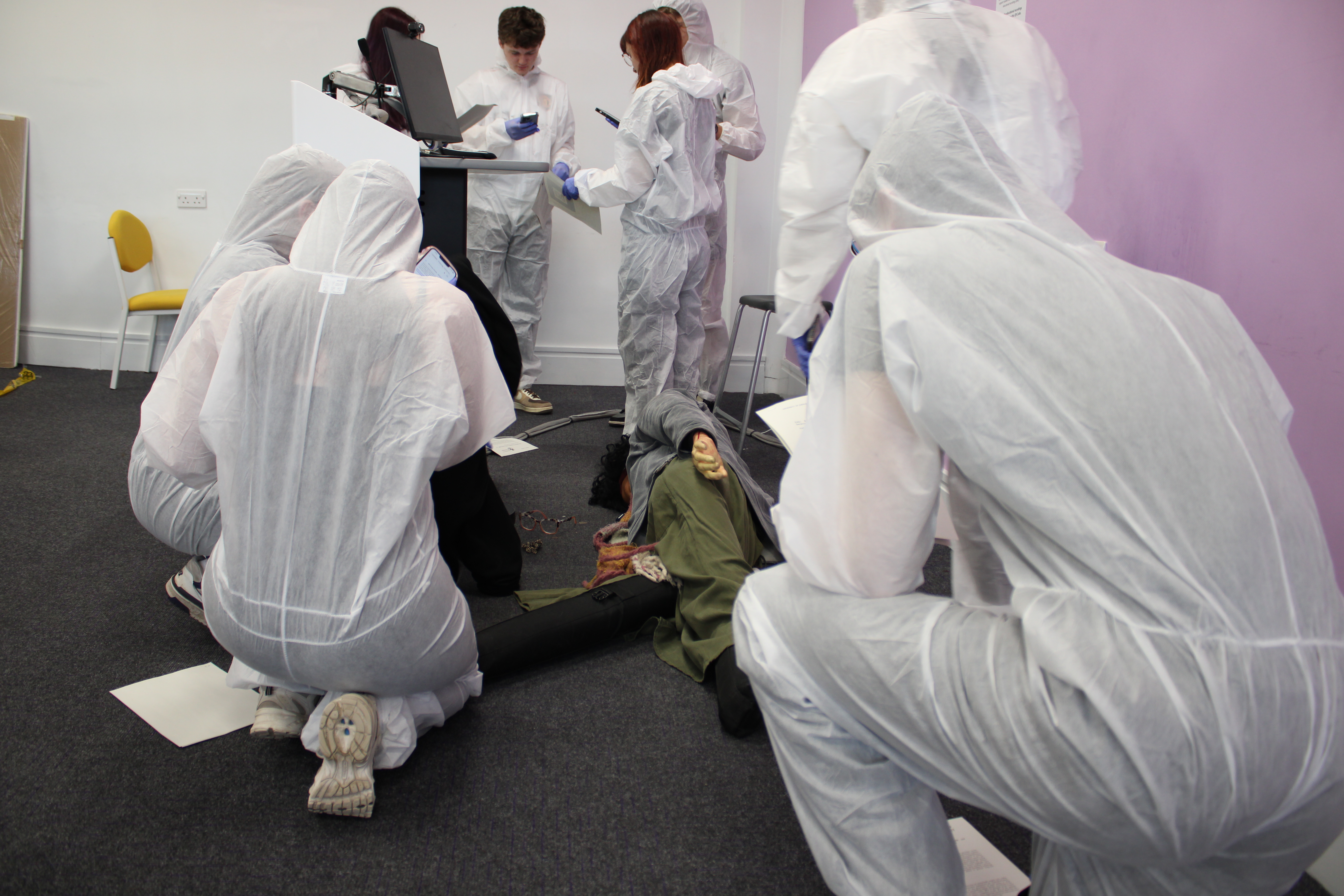 students investigating a fake dead body