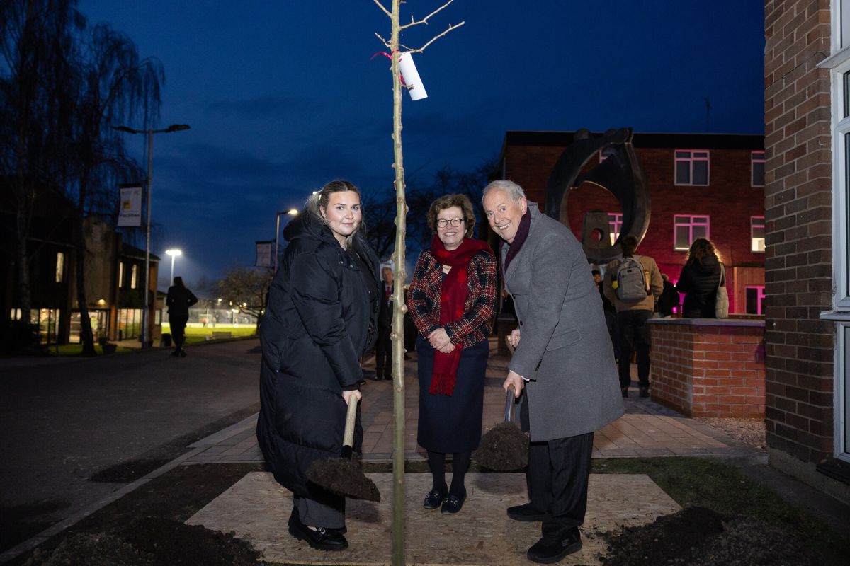 CSU President Lily Watson and Chancellor Gyles Brandreth plant a tree, watched by Vice-Chancellor Professor Eunice Simmons.