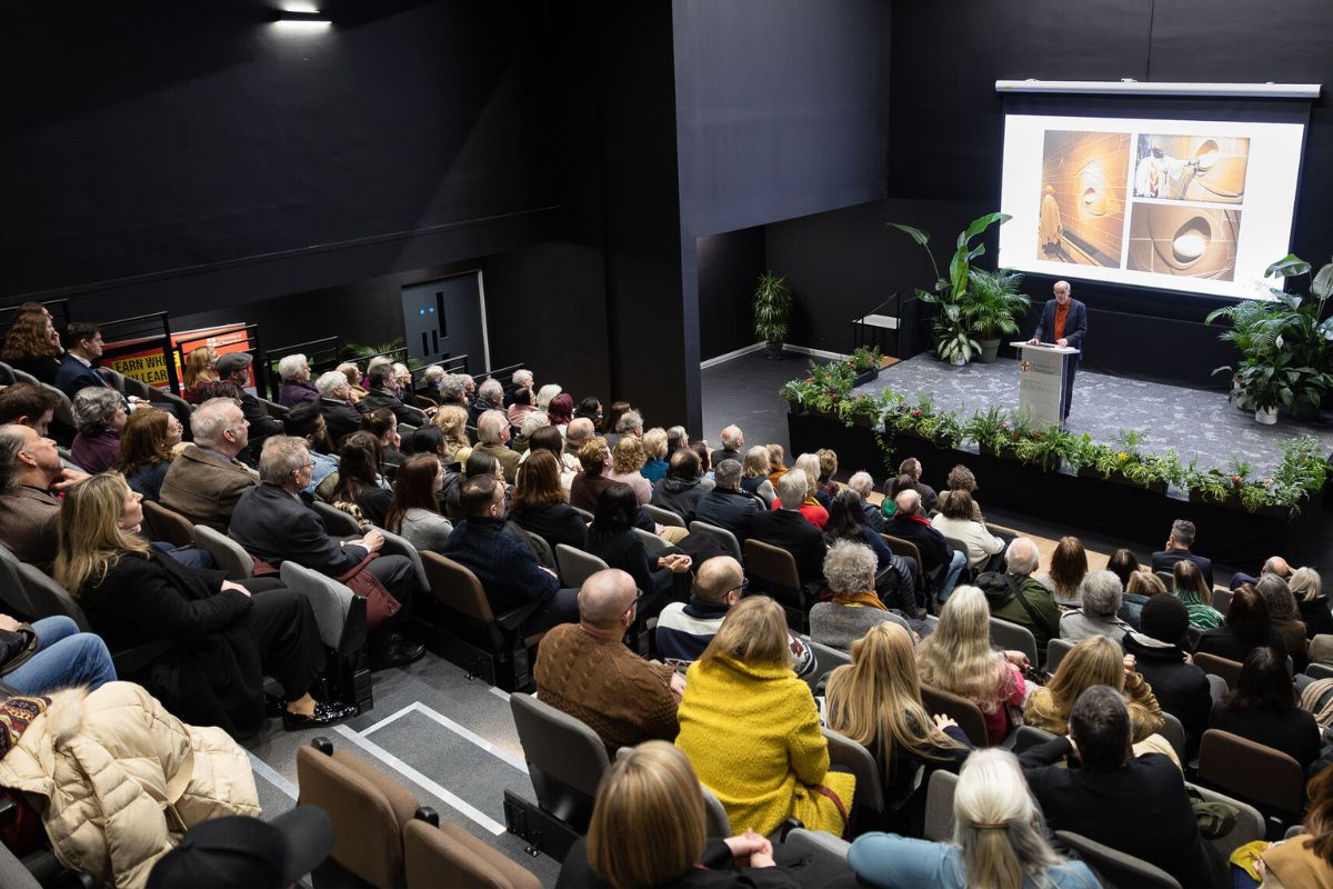 Stephen Broadbent giving a lecture at the School of Education to a crowd of people.