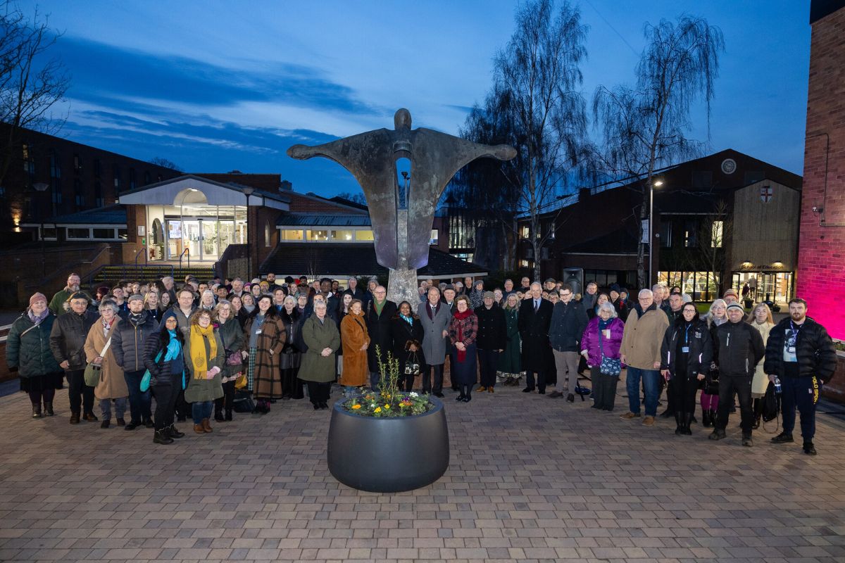 A crowd of people around the Stephen Broadbent sculpture at the University of Chester.