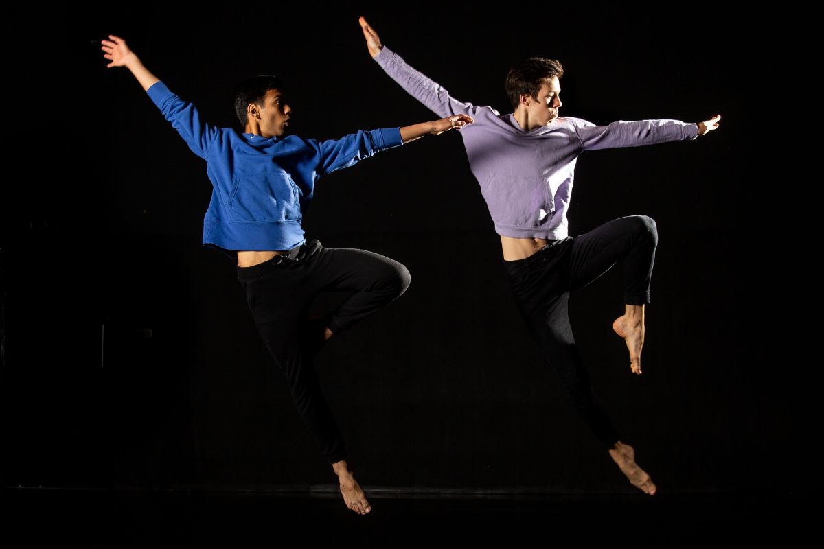 Two students in a synchronised dance pose.