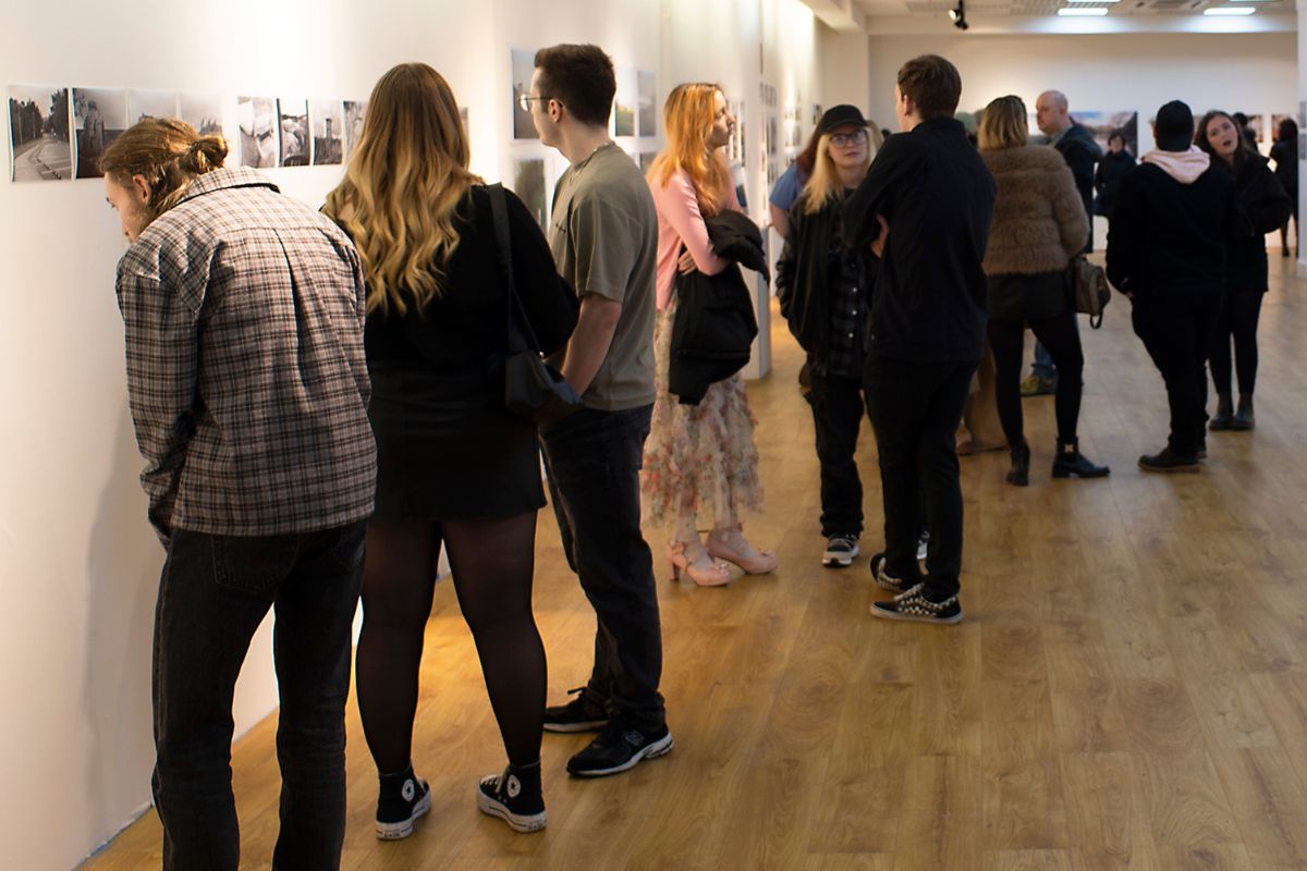 Students looking at the exhibits in the gallery.