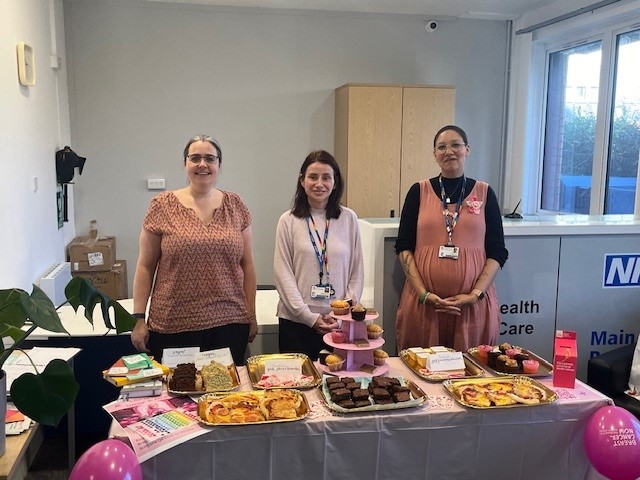 Library staff at a cake stall.
