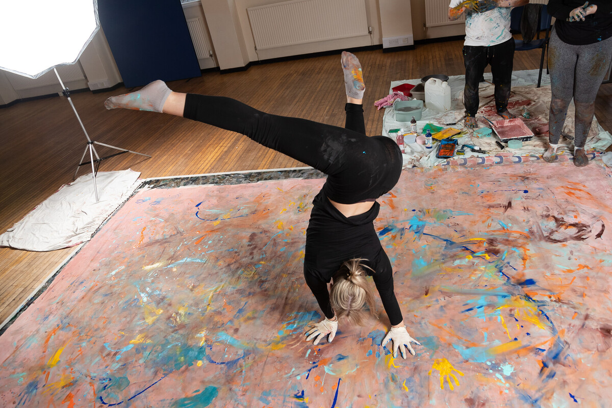 Student dancing and painting