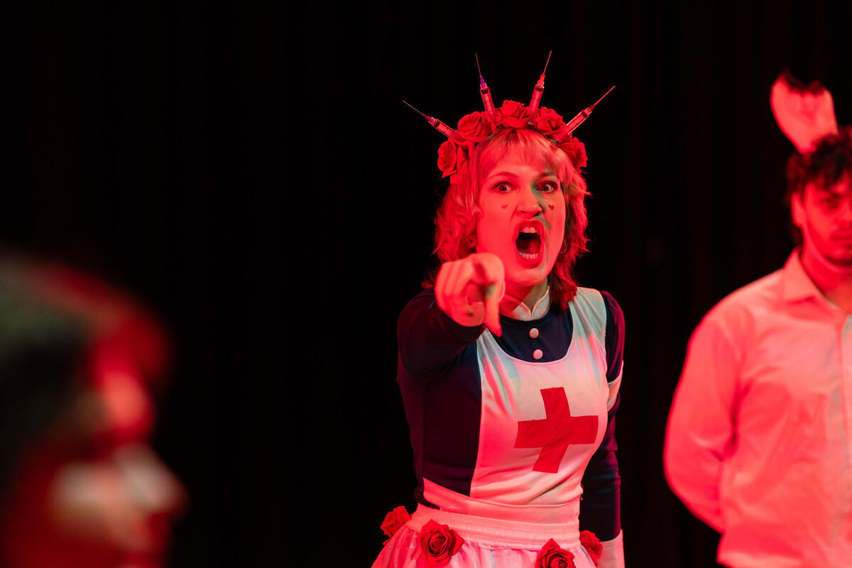 female performer in costume pointing