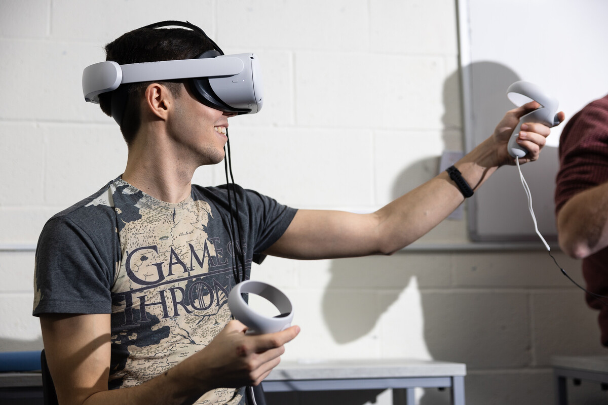 Male student enjoying VR headset during a psychology equipment demo