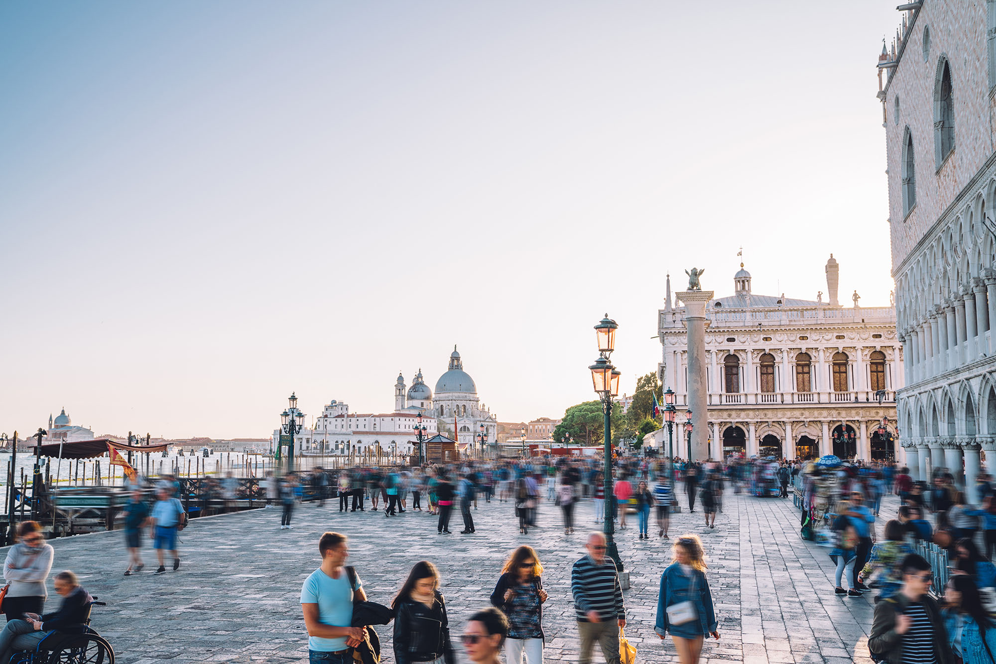 Blurred people on crowded square piazza San Marco with view on cathedral basilica, Venice, Italy.