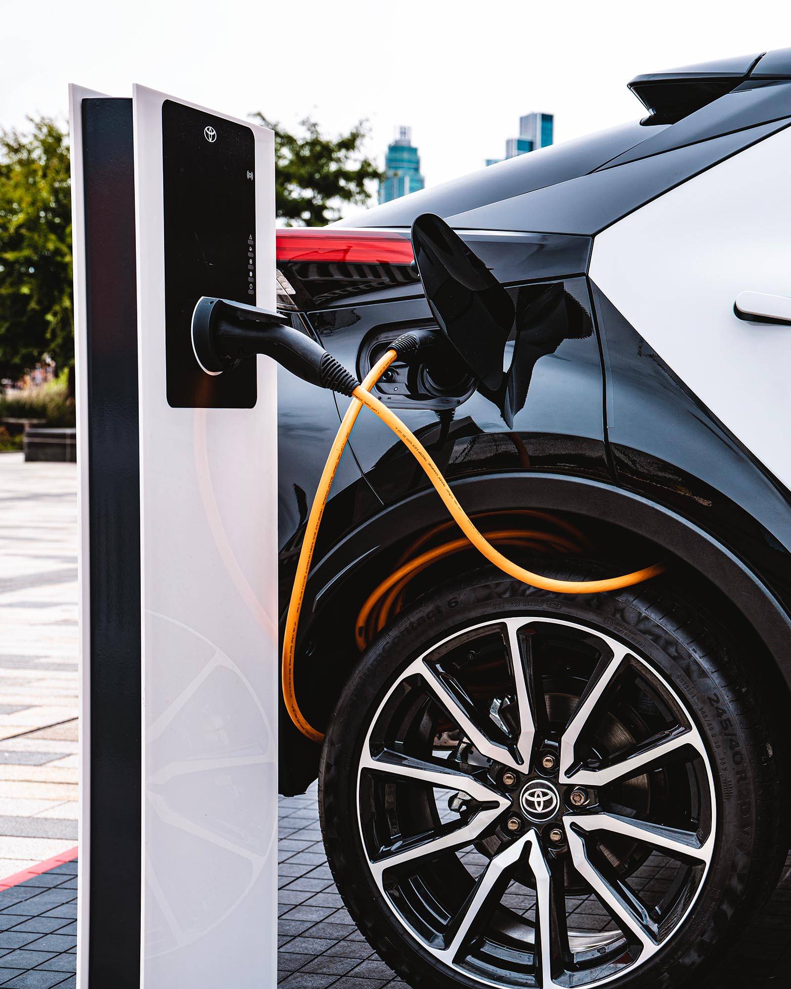 Electric car charger plugged into vehicle